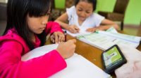 dua orang anak perempuan menonton video pembelajaran untuk PJJ di Kabupaten Tangerang