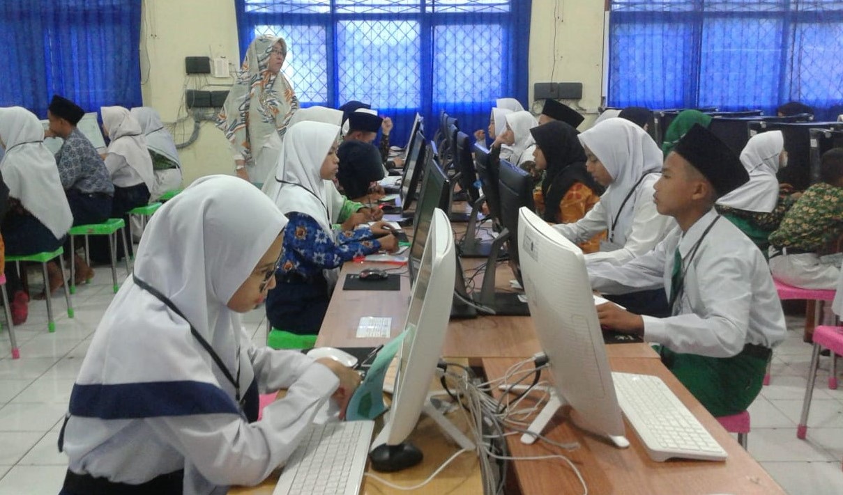 Siswa madrasah sedang belajar mengoperasikan komputer